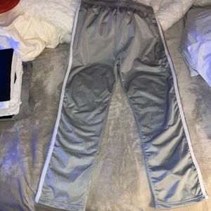 Men’s gray track suit pants with white stripes on the side. Size medium.